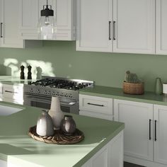 a kitchen with green counter tops and white cabinets