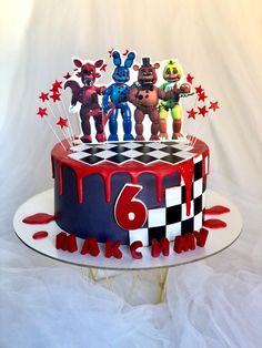 a birthday cake with five toy characters on top and red, white, and blue icing