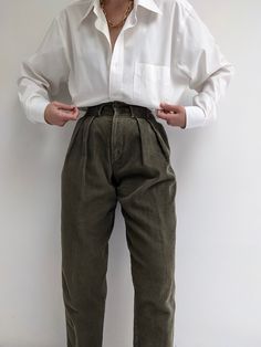 Amazing pleated wide wale corduroys in a lovely moss color. The trousers are perfect weight for the winter months, and feature a high rise, low set belt loops, a front button and zip closure and tapered leg. No material listed, assuming 100% cotton Recommended for size xxs-xs, depending on the desired fit. Modeled on a small frame. Please refer to the measurements listed below: Measures approximately: 24" waist / 40" hips / 12" rise / 26" inseam There is some distressing at the top of the waistb Green Corduroy Bottoms For Work, Khaki Corduroy Bottoms For Fall, Fall Corduroy Khaki Bottoms, Fall Khaki Corduroy Bottoms, Barrel Trousers Outfit, Corduroy Wide Leg Pants With Belt Loops, Wide Leg Corduroy Pants With Belt Loops, Vintage Trousers Outfit, Queer Fall Fashion