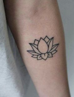 a black and white lotus tattoo on the arm