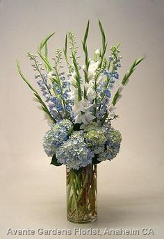 a vase filled with blue and white flowers