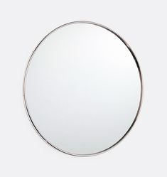 a round mirror is shown on the wall