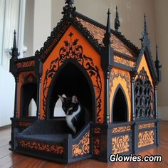 a black and white cat sitting in an ornate dog house