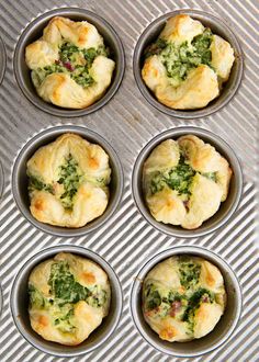 six muffins with broccoli and other toppings in a metal pan