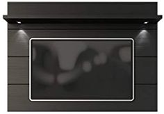 a black wall mounted oven with lights on it