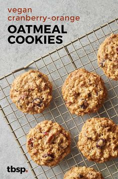 an image of oatmeal cookies on a cooling rack with the words vegan cranberry - orange oatmeal cookies