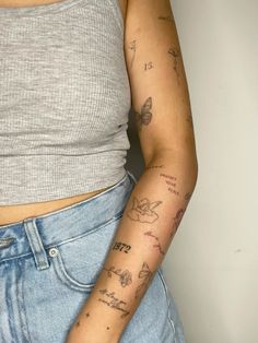 a woman's arm with tattoos on it