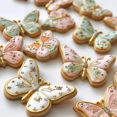 decorated cookies are arranged in the shape of butterflies