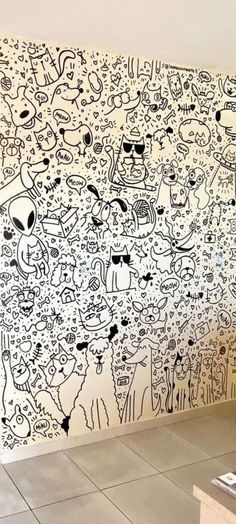 the wall is covered with many drawings on it