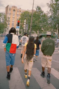 several people walking down the street with long hair