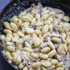 macaroni and cheese with mushrooms in a skillet