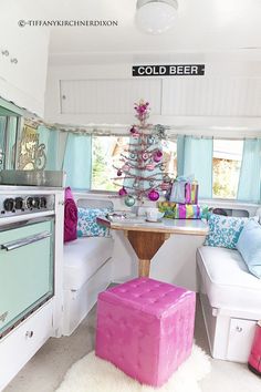 a small kitchen with pink and blue decor