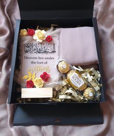 an open gift box with roses and other items