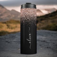 a black and pink glittered can cooler with the word faith written on it in white ink