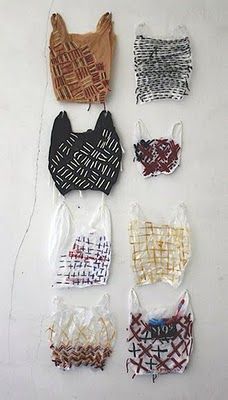 six different types of bras hanging on a white wall with string attached to them