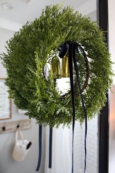 a wreath with two bells hanging from it