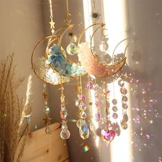 a wind chime hanging from the side of a window with stars and moon on it