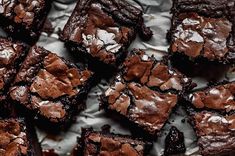 brownies with chocolate frosting sitting on top of a table