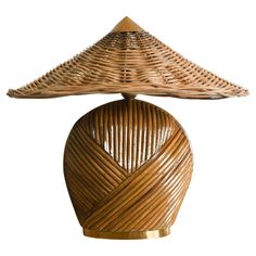 a table lamp made out of wicker on top of a wooden base