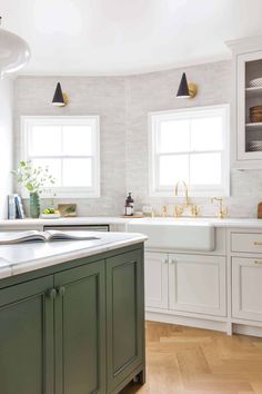 a kitchen with green cabinets and white counter tops