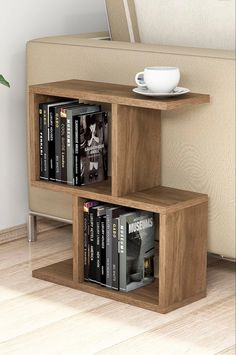 two bookshelves are stacked next to each other in front of a beige couch