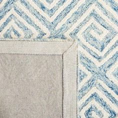 an area rug with blue and white designs on it