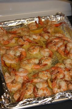 cooked shrimp and peppers on aluminum foil in an oven