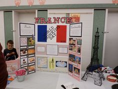 there is a display on the table with pictures and information about france in front of it