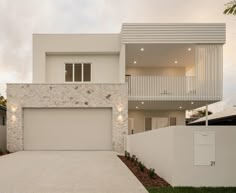 a white house with two stories and a garage