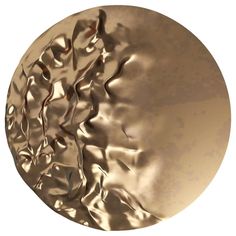 a gold plate with wavy metal designs on it