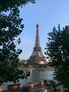 the eiffel tower is lit up at night