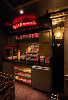 the interior of a fast food restaurant with neon signs above it and snacks on display