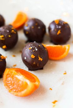 chocolate oranges are arranged on a white surface