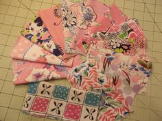 several pieces of fabric laid out on a cutting board