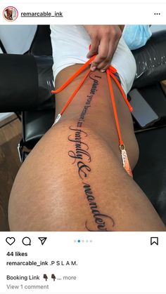 a woman with an orange ribbon around her leg and writing on the side of her thigh