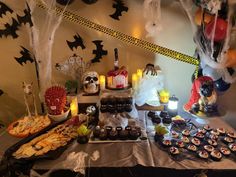 a table topped with lots of halloween treats