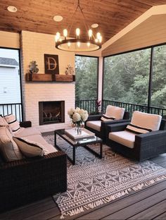 a living room with two couches and a fire place in the middle of it