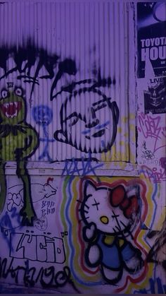 graffiti on the side of a building with an image of a hello kitty and other characters