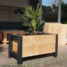 a planter box sitting on the side of a sidewalk