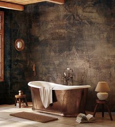 an old fashioned bathtub in a rustic bathroom with brown walls and wood flooring