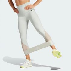 a woman in white sports bra top and leggings