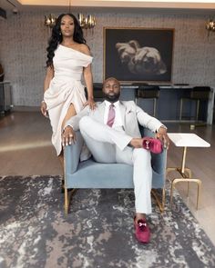 a man and woman sitting on a blue chair