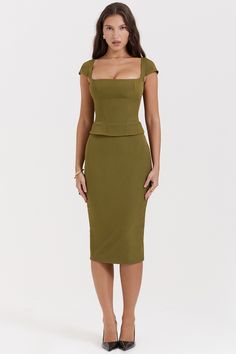 Details 
Layana Olive Corset Midi Dress is incredibly chic. Cut from peached twill for a softly brushed texture. it features a corseted bodice to cinch the waist and is topped with a flattering square neckline and dainty cap sleeves.

We love how the fitted skirt falls to a classy long midi length as it skims over your curves and has a split to the back for easy movement. 'Layana' is fully lined for comfort and zips up the back for easy on. 
Size Chart
            BUST WAIST HIP LENGTH   XS 84cm เสื้อผ้า Kylie Jenner, Corset Midi Dress, Bodycon Midi Skirt, French Dress, Office Dresses For Women, Square Neck Top, Mid Length Skirts, Fall Skirts, Sleeveless Crop Top