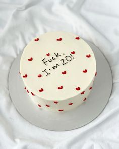 a white cake with red hearts and the words futt in 20 written on it