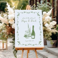 an easel with a sign and flowers on it