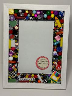 a photo frame made out of buttons and other items