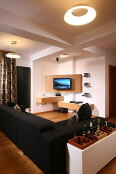 a living room filled with furniture and a flat screen tv mounted to the side of a wall