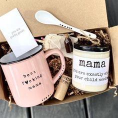 a pink coffee mug and spoon in a box