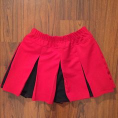 Red And Black Cheerleader Skirt. Thick Material Holds Its Shape. Size Medium. Elastic Waistband Hits At The Waist. Brand New! Red Skort For School In Spring, Red Mini Tennis Skirt For School, Red Mini Skirt For School In Summer, Stretch Red Lined Tennis Skirt, Stretch Red Tennis Skirt With Lining, Casual Red Skort For School, Red Stretch Lined Tennis Skirt, Casual Red Tennis Skirt For School, Red Stretch Tennis Skirt With Lining