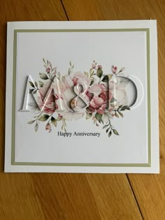 an anniversary card with flowers and the word m & w written in cursive letters